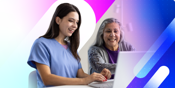 A young female eye care professional wearing scrubs sits beside an older woman with gray hair, both smiling and looking at a laptop screen