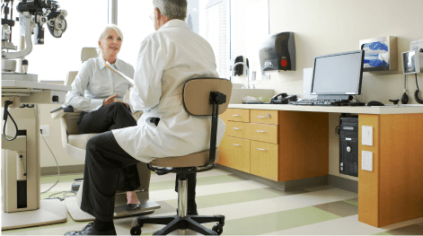 An older woman visiting her eye doctor about cataracts.