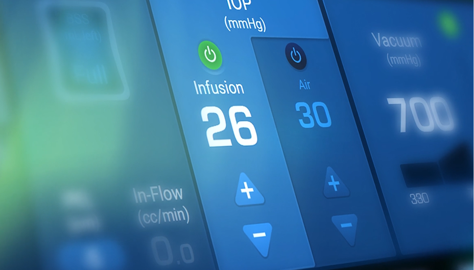 Close-up of a surgical system touchscreen showing infusion at 26 mmHg, air at 30, and vacuum at 700 mmHg with control buttons