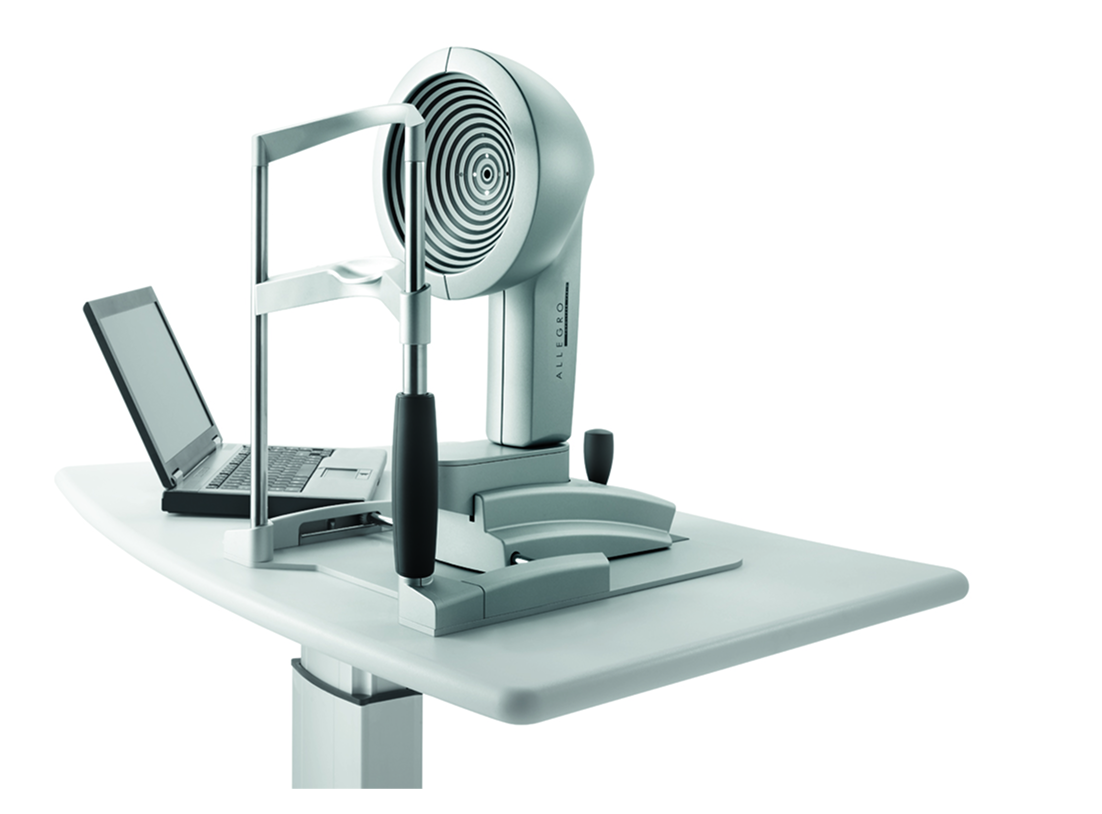 Wavelight Topolyzer VARIO corneal topographer with Placido-ring pattern, laptop, and patient chin rest on an exam table.