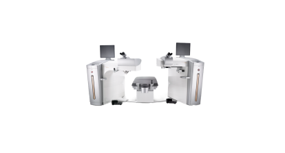 Alcon LASIK surgical suite featuring two laser systems positioned on either side of a central patient bed, with monitors and microscopes for precision eye surgery.
