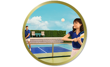 Woman playing tennis on an outdoor court while a man stands on the opposite side of the net