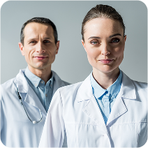 A male and a female healthcare professional confidently pose in their white coats.