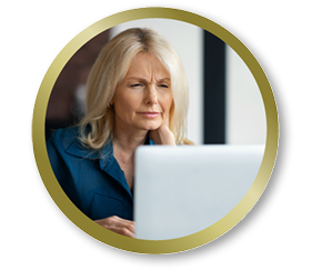 Woman looking at her computer screen with a focused expression