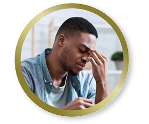 Man rubbing his eyes, representing discomfort or eye strain from vision challenges