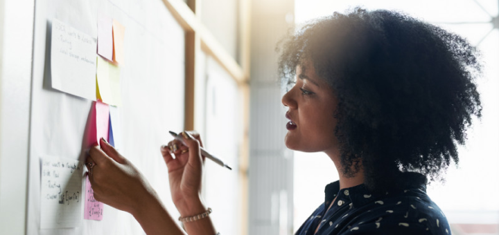 Woman making a notes on a board