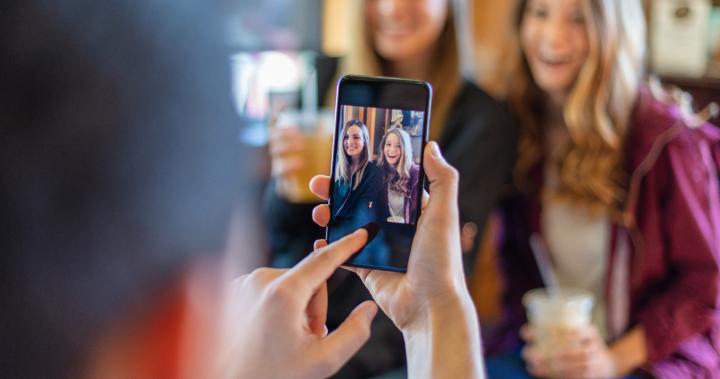 Woman taking photo of friends