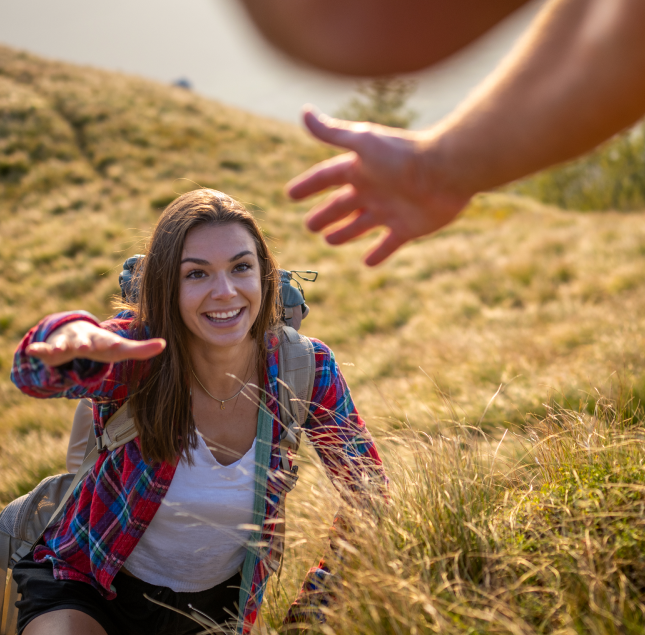 Woman giving hand to another person